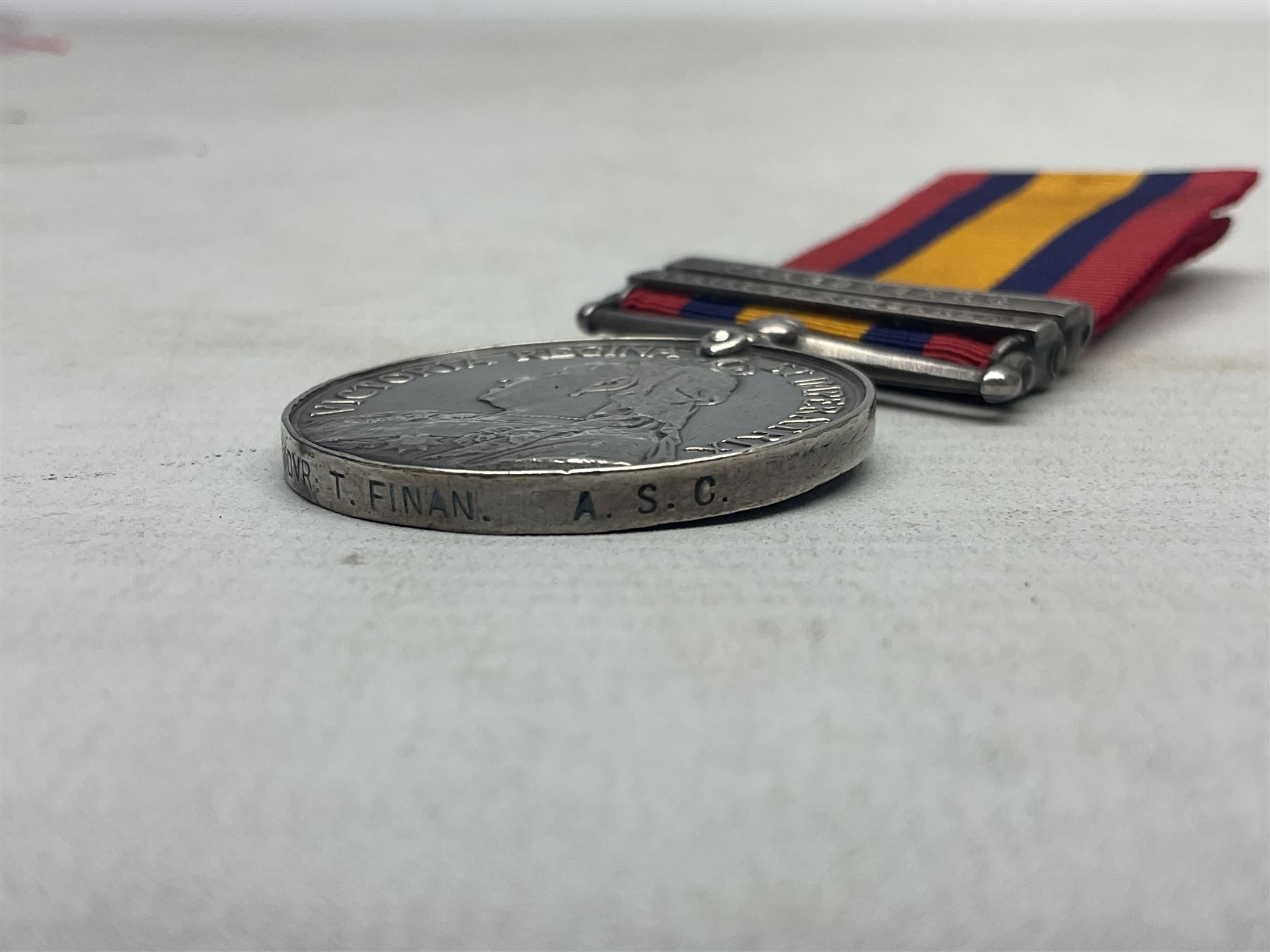 Boer War pair of medals comprising Queens South Africa Medal with two clasps for Paardeberg and Relief of Kimberley and Kings South Africa Medal with two clasps for South Africa 1901 & 1902, awarded to 9752 Dvr. T. Finan A.S.C. with ribbons (2)
