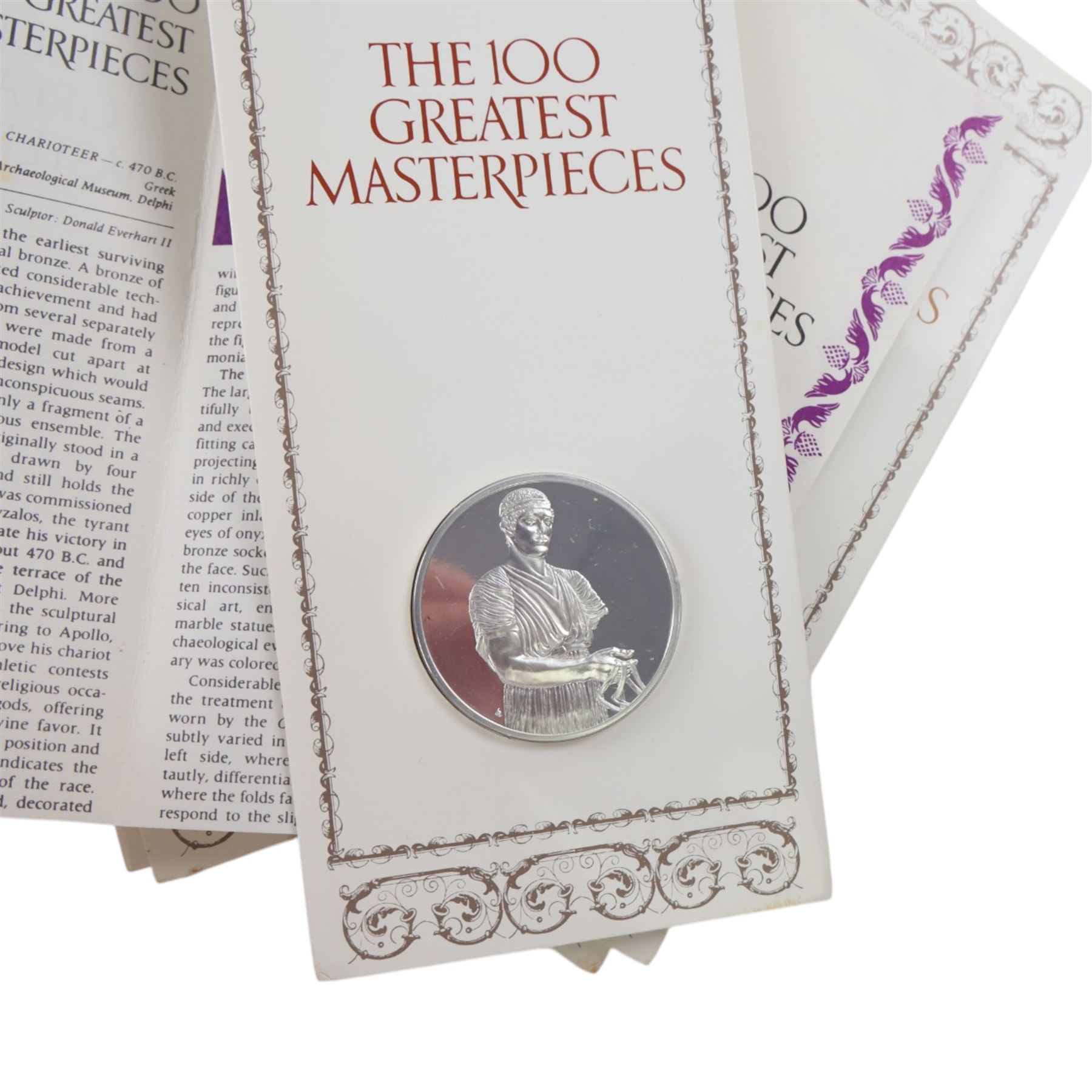 John Pinches 'The 100 Greatest Masterpieces' set of one hundred silver medallions, each on presentation card with information leaflet, together with the corresponding wooden display cabinet
