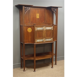  Art Nouveau mahogany inlaid side cabinet with raised panelled back, central inlaid floral panel, top supported by two carved supports above central break-front cupboard enclosed by two panelled doors with pierced metal strap work, square tapering supports with flared square pad feet connected by undertier, back stamped 'Design 4414 2618 4', W122cm, H163cm, D40cm   