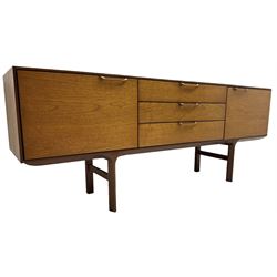 Mid-20th century teak sideboard, fitted with three central drawers flanked by cupboards