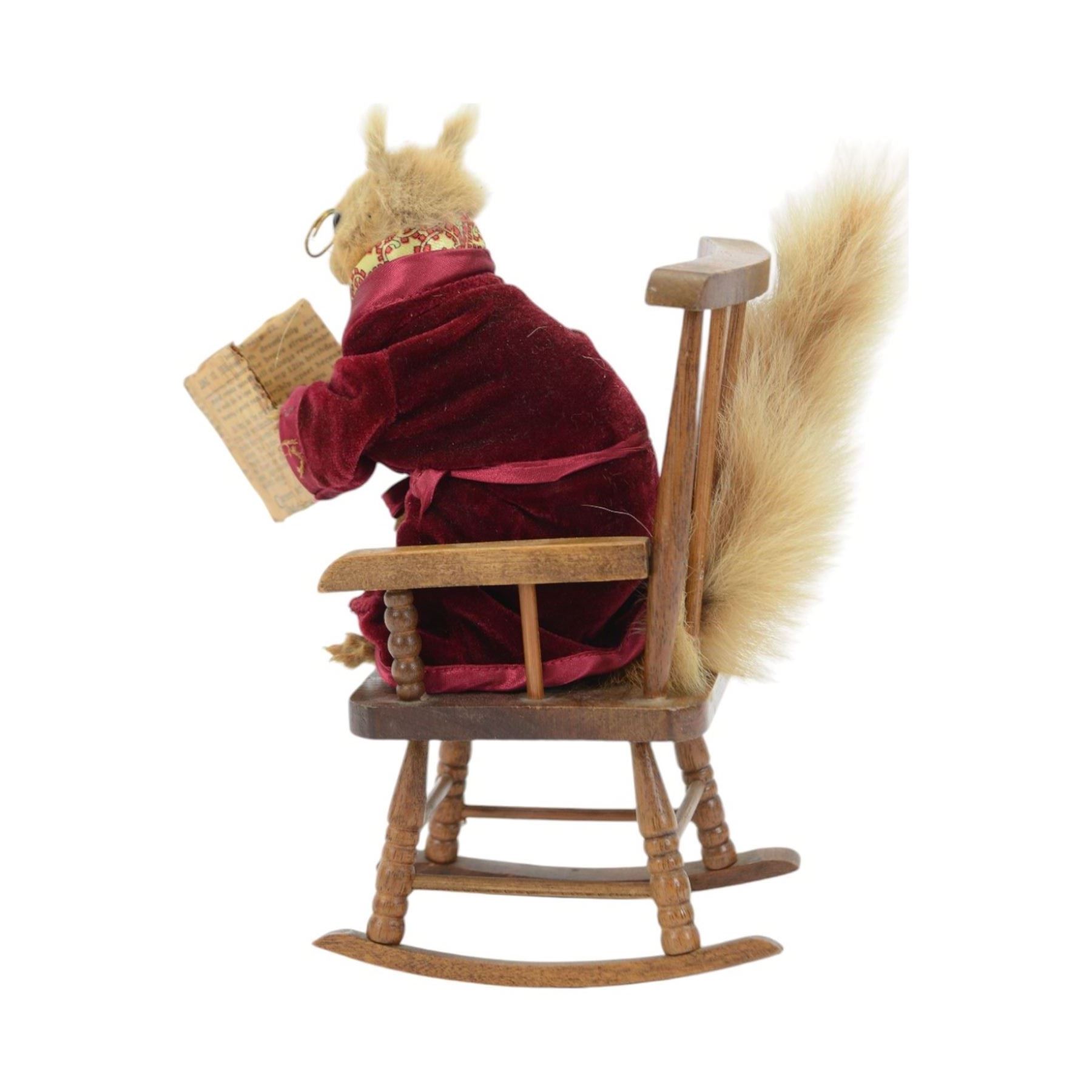 Anthropomorphic Taxidermy: Red squirrel (Sciurus vulgaris), dressed in a velvet dressing gown upon a rocking chair reading a newspaper from 1936, H28cm