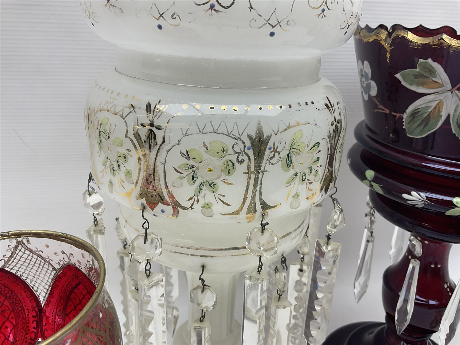 Bohemian red glass lustre, painted with stylised floral and foliate decoration, together with a milk glass example and two bohemian goblets converted to lustres 