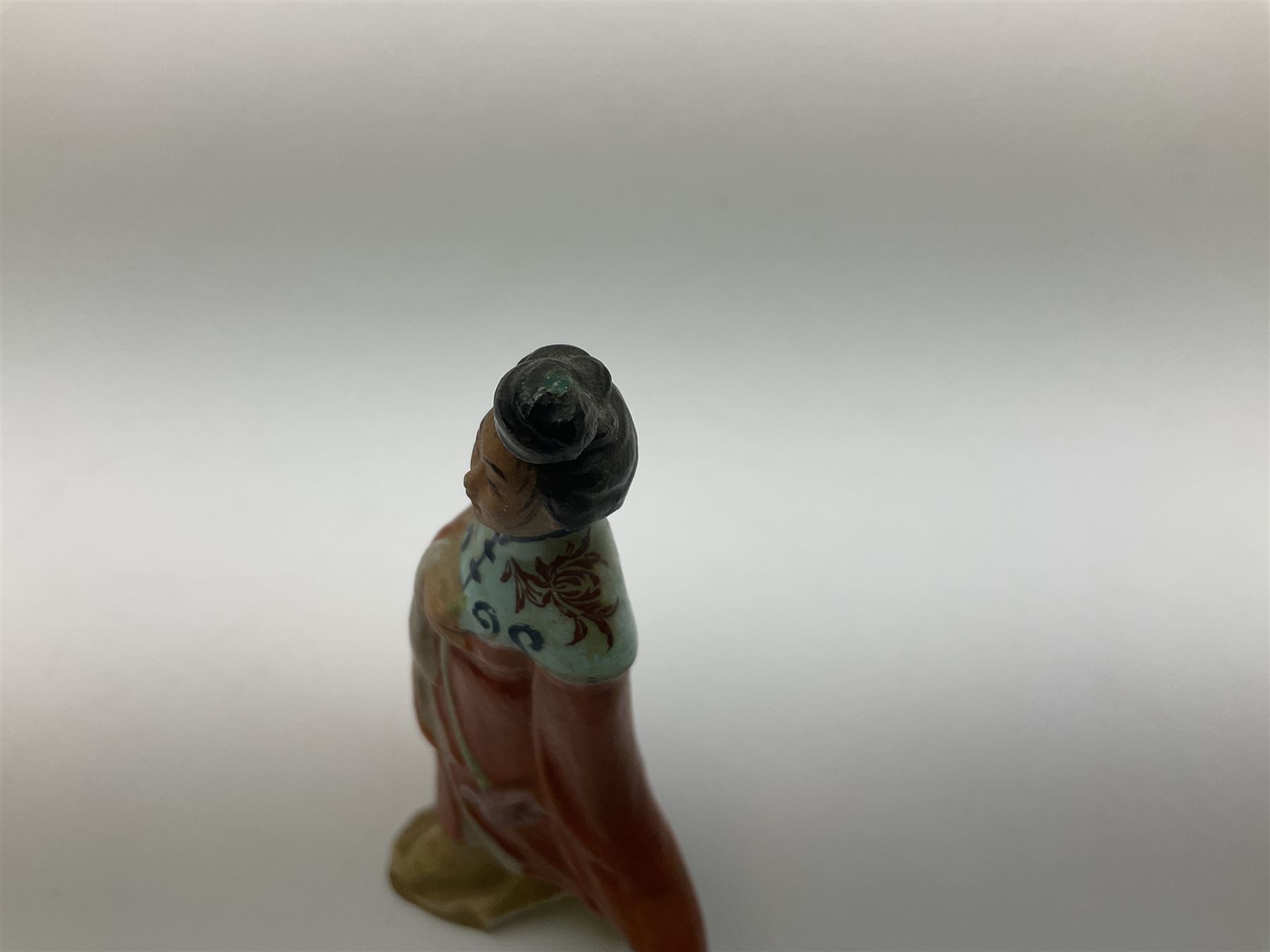 Japanese parquetry puzzle box L12cm; another Japanese puzzle box with marquetry top of Mount Fuji; eleven graduated Chinese figures including immortals; and Chinese figure of a lady standing on a hardwood base next to a horn table (14)