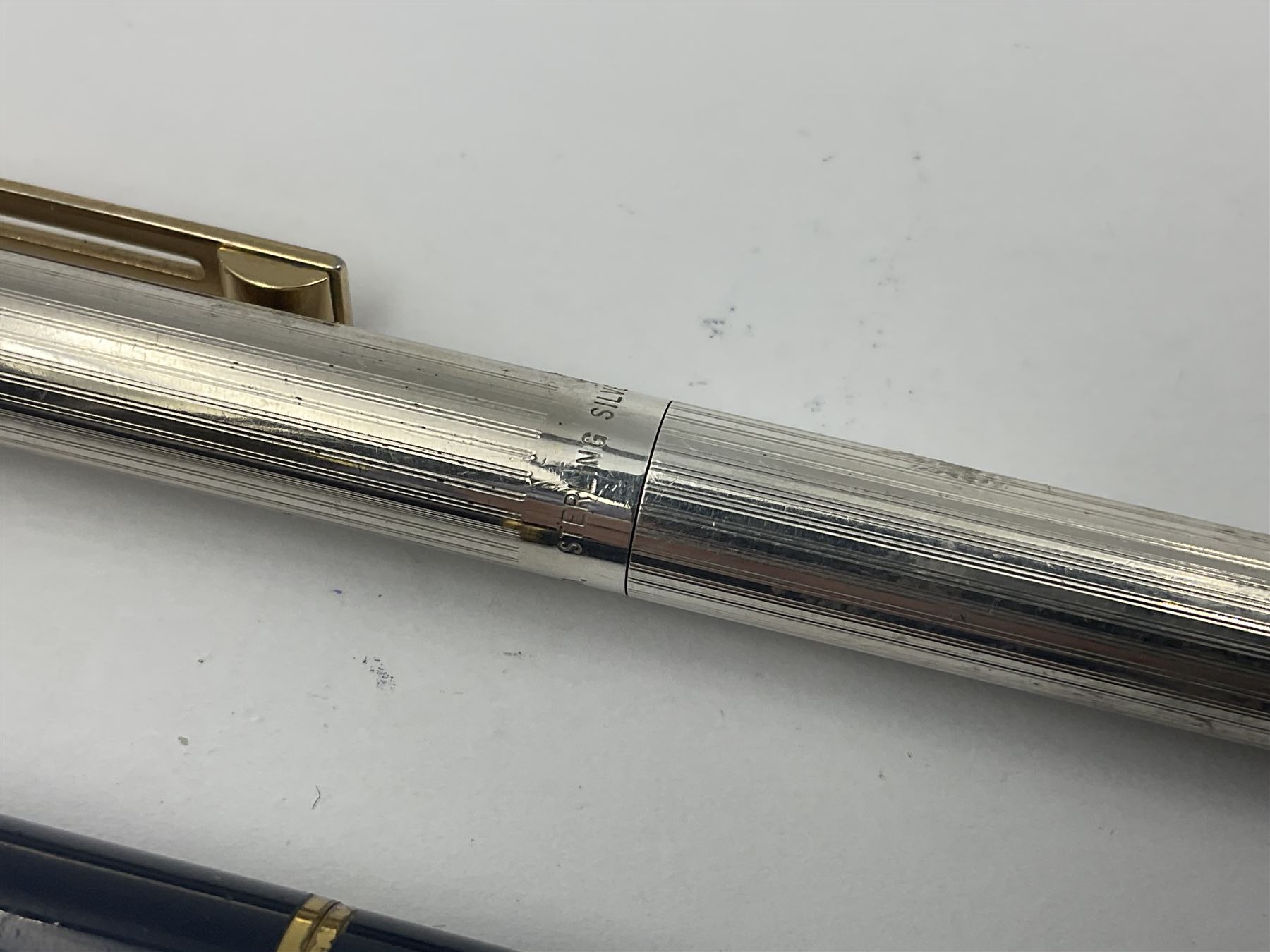 Sheaffer Targa 1011 Diamond Square fountain pen, the gold plated barrel with nib stamped 14K 585, together with another Sheaffer Targa fountain pen with blue barrel and gold nib stamped 14K 585 and matching ballpoint, and Sheaffer ballpoint pen with sterling silver barrel, largest L13.5cm (4)