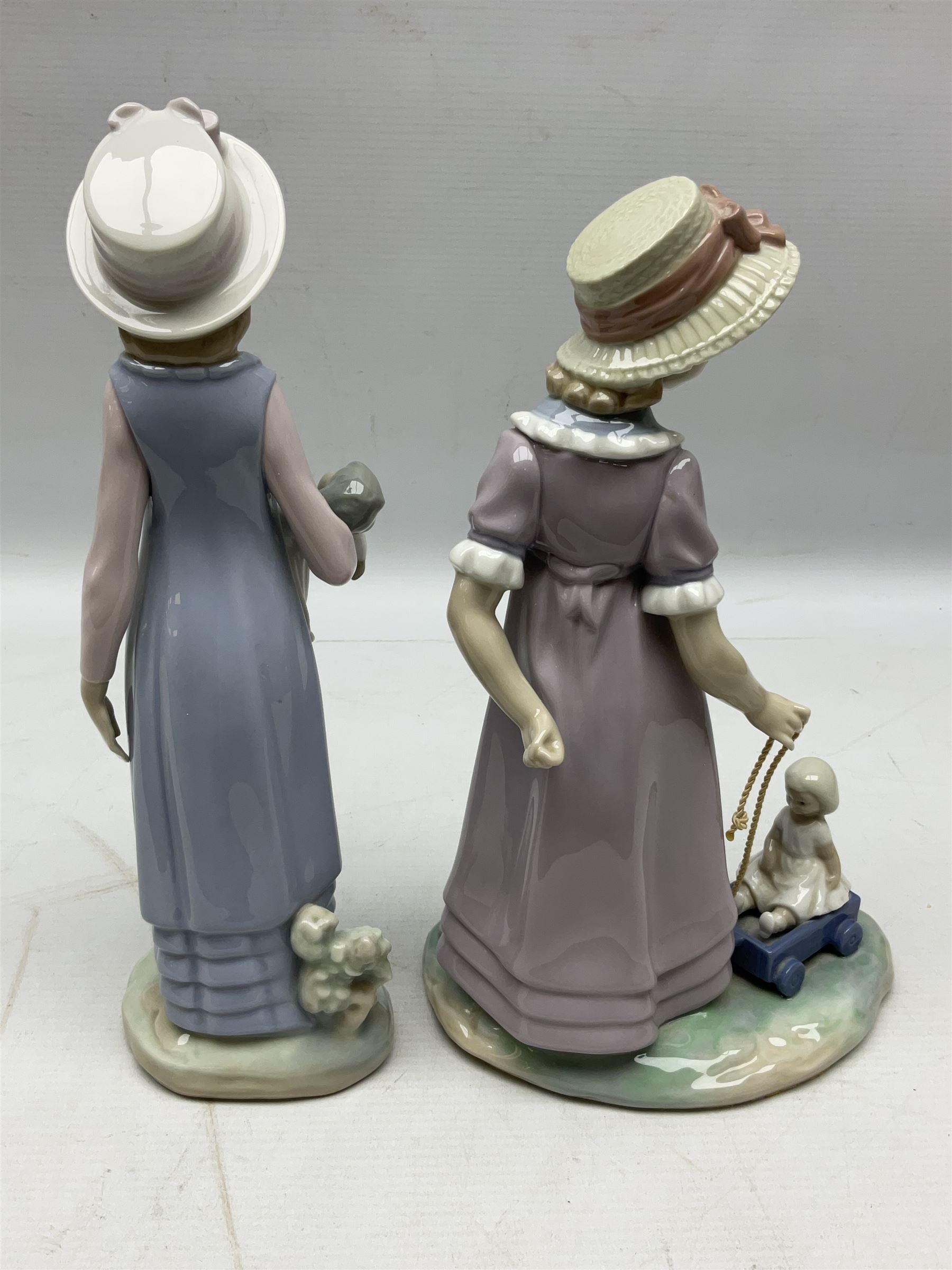 Four Lladro figures, comprising Pulling Dolls Carriage no 5044, Belinda with her Doll no 5045, Pretty Pickings no 5222 and Shepherdess with basket no 4678 
