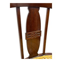 Late Victorian mahogany framed tub chair, rounded backrest with vertical splats and three carved oval medallions, upholstered seat in yellow patterned fabric, on cabriole supports