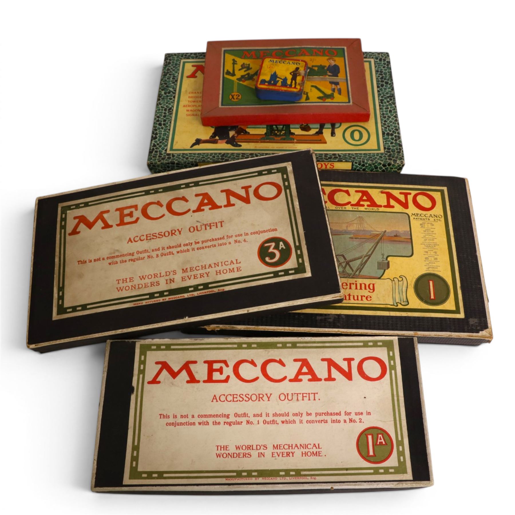 Early 20th century Meccano outfits, comprising 'Engineering in Miniature' set no. 1, 'Engineering for Boys' set no. 0, Accessory Outfit no. 1A, Accessory Outfit no. 3A and one other