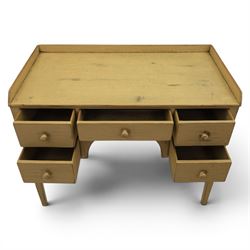 Pine country writing desk, rustic cream paint finish, galleried top over a central drawer flanked by two drawers, tapered square supports