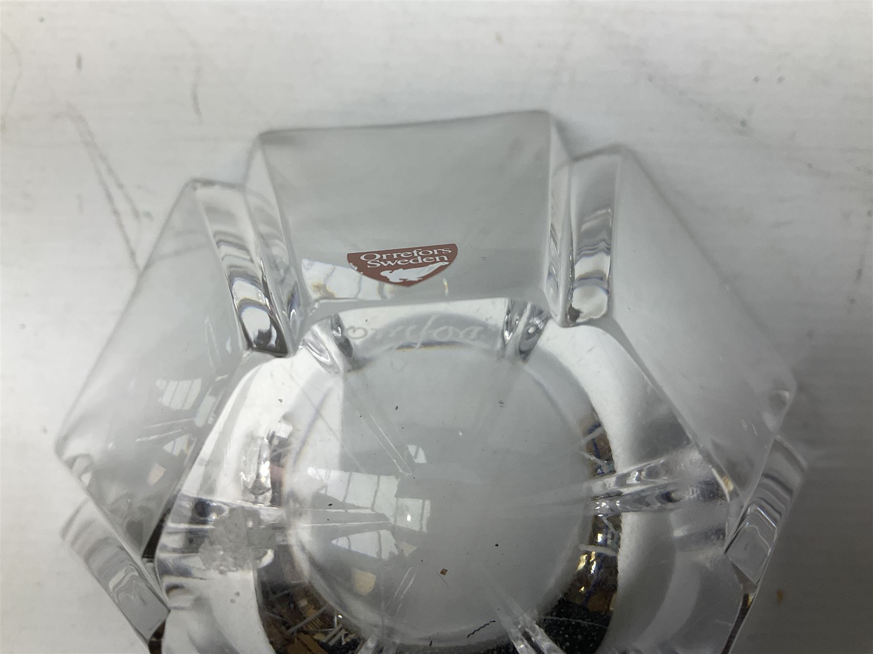 Two Orrefors Art Glass clear glass vases, the first example of compressed circular form, the second of tapering form with lobed rim, each signed beneath, tallest H14.5cm