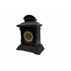 An early 20th century fourteen-day German mantle clock in a wooden case striking the hours on a coiled gong, two-part dial with a gilt centre, ivorine chapter ring with roman numerals, minute track and half-hour markers, steel Fleur de Lys hands and brass spun bezel, case on a splayed stepped plinth with cluster columns, wide cornice and carved broken arch pediment, original Hamburg American Clock Company (HAC) trade labels attached inside the case door.