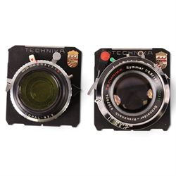 Linhof Tecnika 70 medium format press camera serial no. 1711919, with a Xenotar 1:2.8/80 lens serial no. 9254350 and a Symmar 1:5.6/180 lens serial no. 8357904, both coupled to the camera, and additional accessories including Symmar-S 5.6/100 lens, and a Carl Zeiss Jena Apo-Lanthar 40mm1:4.5 macrolens, numbered set of seven Linhof dark slides, super rollex roll film holder and anatomical grip, all contained within modern case