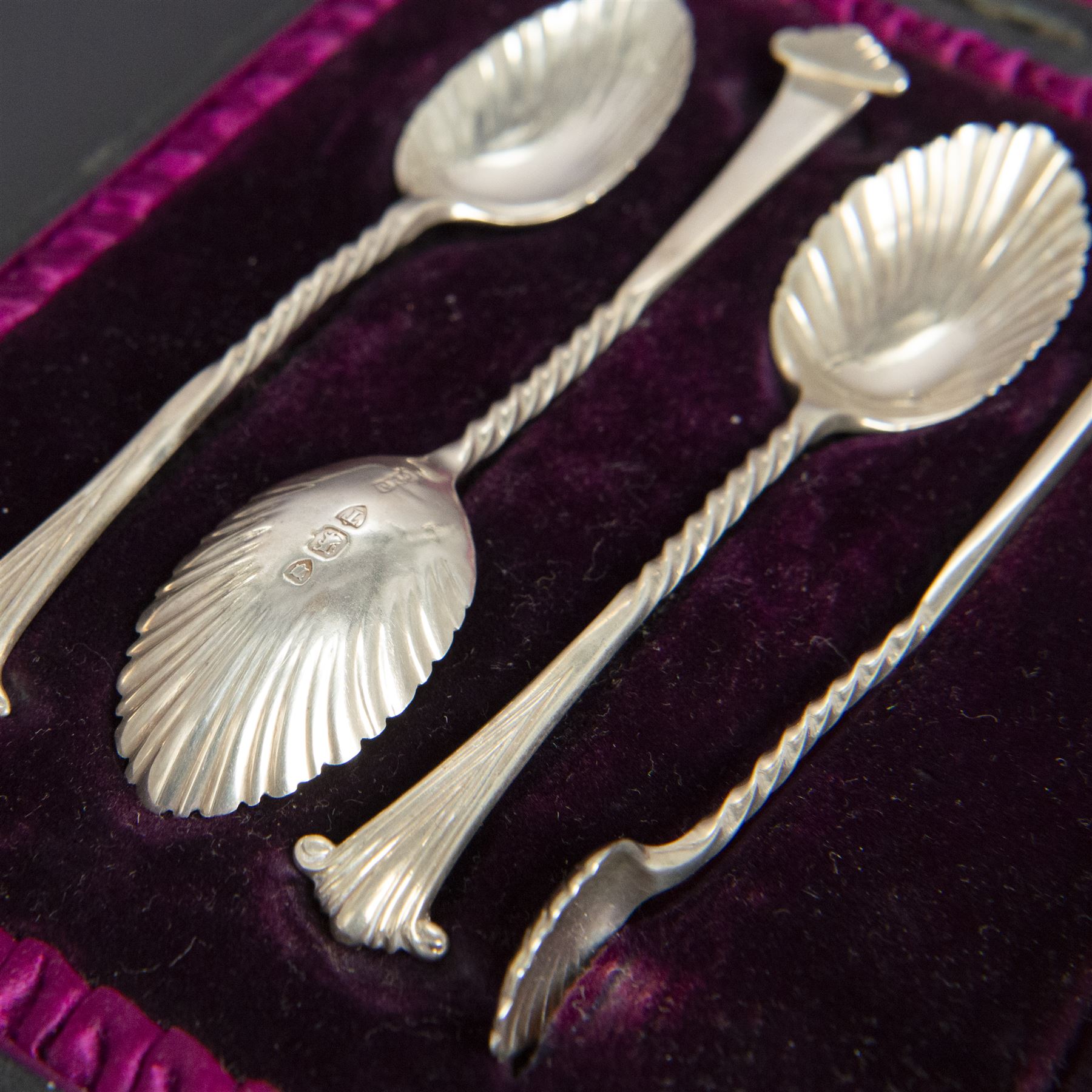 Set of six late Vitorian silver spoons and sugar tongs, each with twist and scroll handles and fluted bowls, hallmarked 	Josiah Williams & Co, London 1894, contained within fitted case