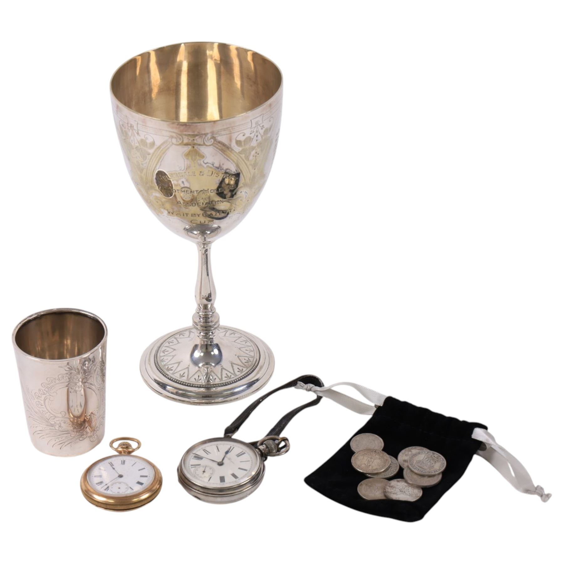 German silver beaker (800 standard), silver plated trophy cup, silver pocket watch, gold plated screw back pocket watch, five silver shilling coins, and some further coins