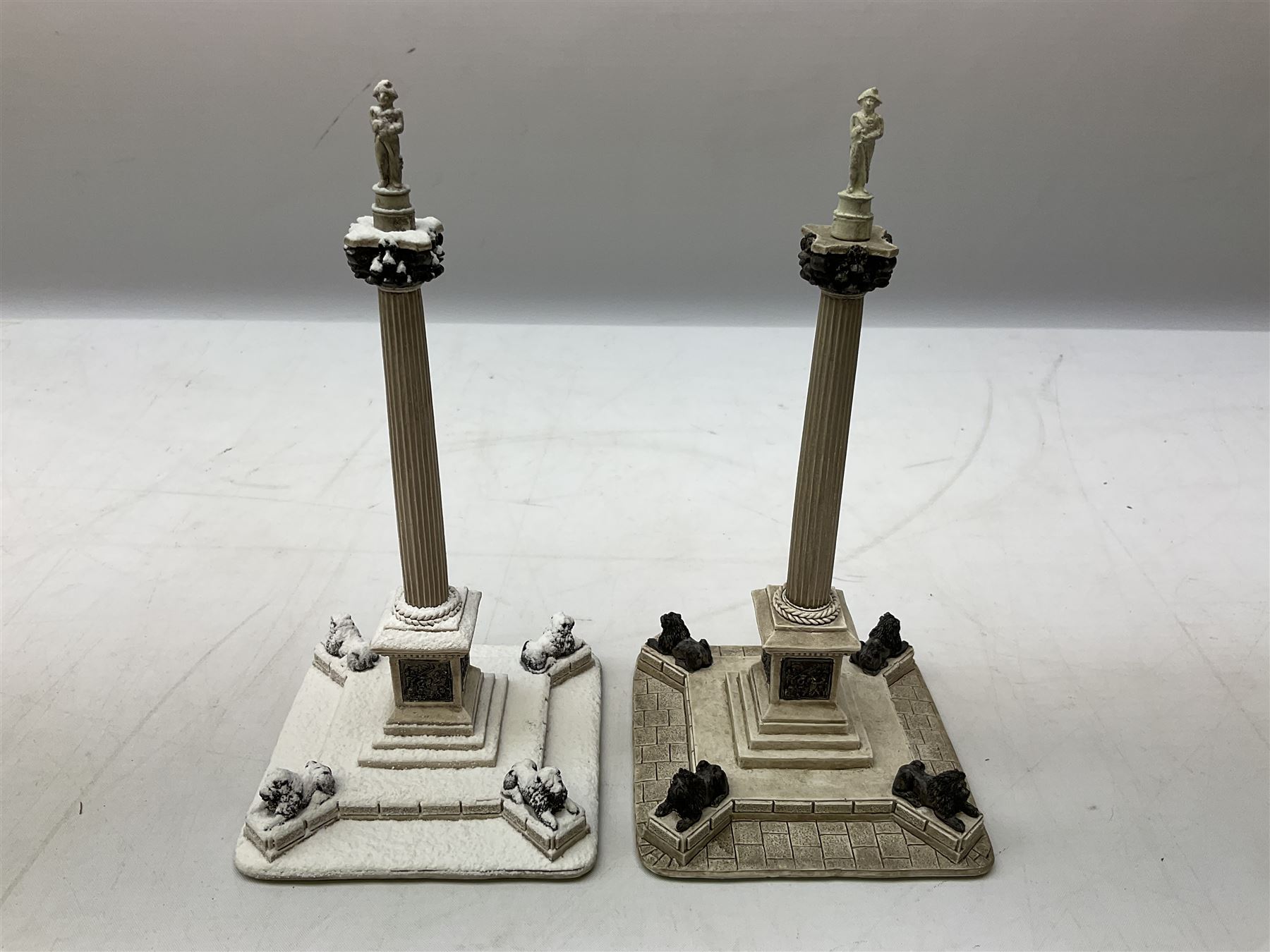 Five Lilliput Lane models from the 'Britain's Heritage' collection, comprising The Royal Albert Hall, Windsor Castle Round Tower, Eros and Nelson's Column and another snowed, all boxed