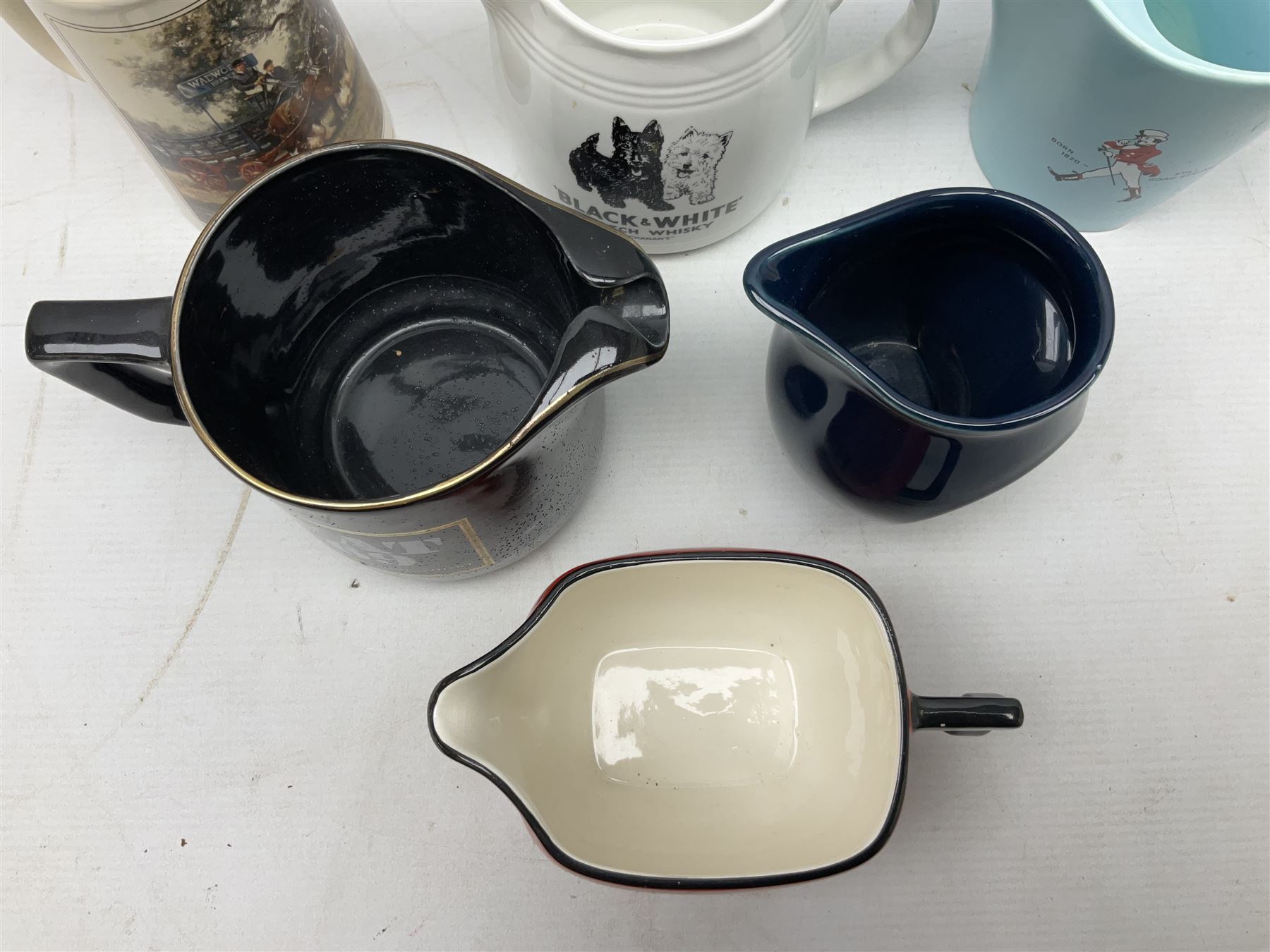 Six whisky water jugs, to include Wade Johnnie Walker, Haig, Black & White, etc