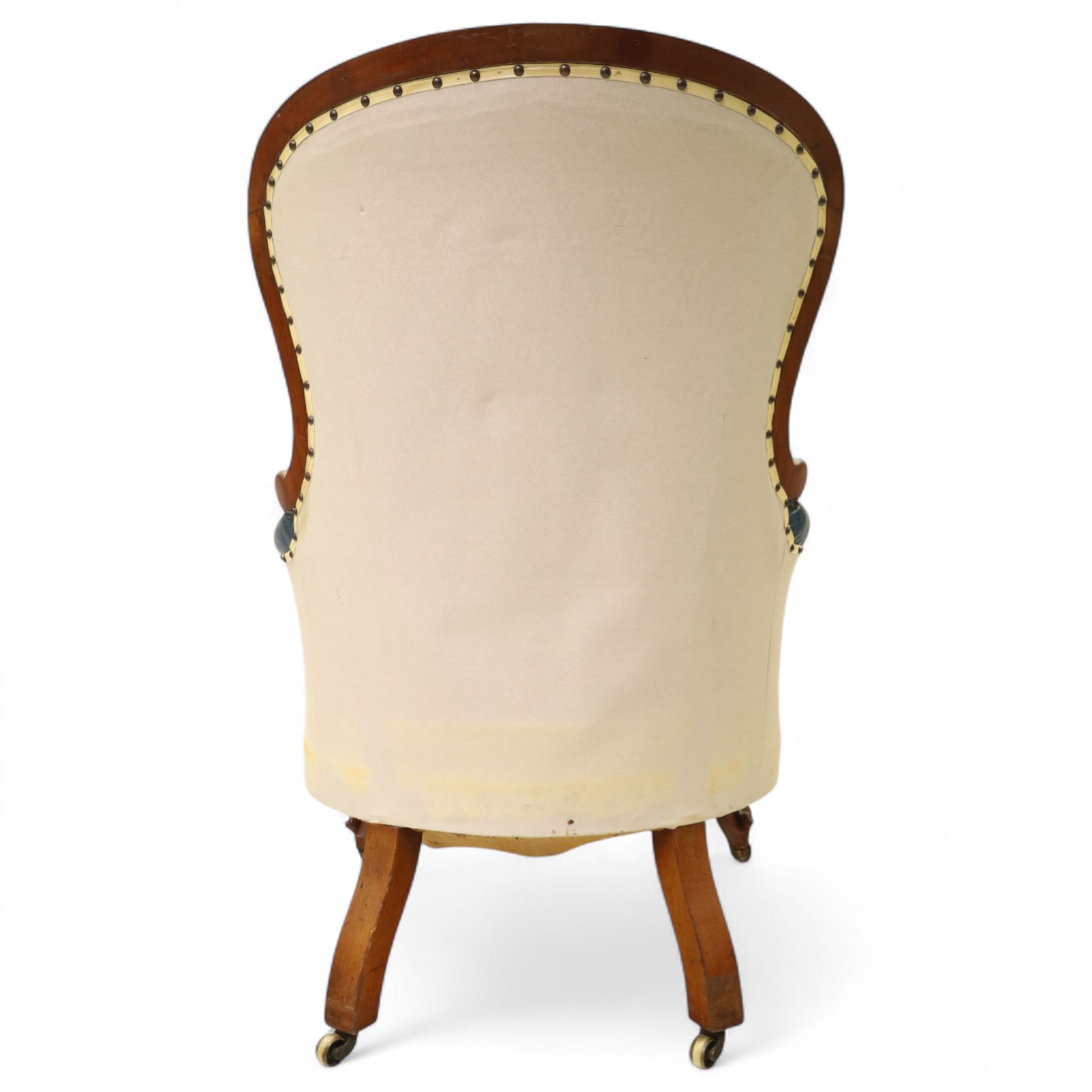 Fine pair of mid-19th-century mahogany library armchairs, carved frame with balloon-shaped back with scrolled ends, rolled wide arms, ending in a scrolled volute above a serpentine seat rail, upholstered in mottled turquoise faux leather, button upholstered back, arms, and cushion seat, studded sides and apron, raised on scroll carved front feet and splayed rear legs on castors 