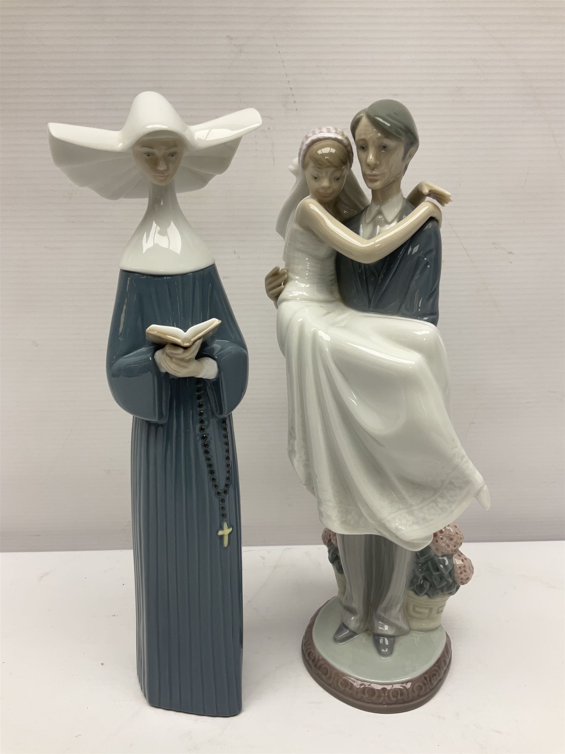 Two Lladro figures, Over the Threshold no 5282 and Prayful Moment no 5500 together with five Nao figures