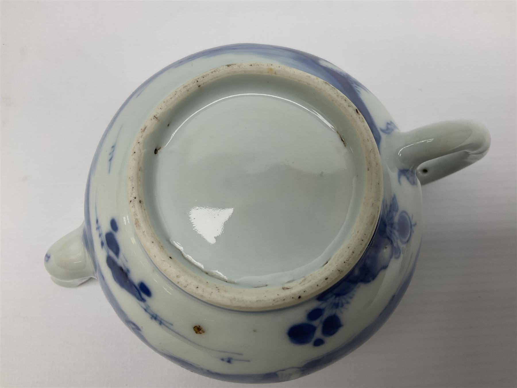 Two late 18th/early 19th century Chinese export teapots, the largest example of globular form with curved handle and straight spout, decorated in the Mandarin style with figural scenes surrounded by red scale reserves, H13.5cm, the second smaller example decorated in underglaze blue with two musicians in a landscape set with willow tree and fence, H10.5cm

