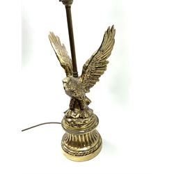 A brass table lamp modelled in the form of an eagle upon a circular base, overall H73cm.