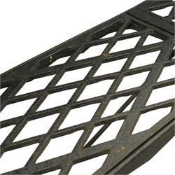 Two cast iron garden benches, rectangular seat with lozenge grate panels, on X-framed supports 