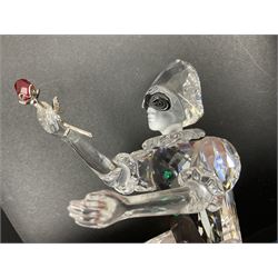 Swarovski Crystal Masquerade trilogy; 1999 Masquerade Pierrot, 2000 Columbine, 2001 Harlequin all with accompanying plaque, stand and original box, together with a glass display case with mirrored back and sides 