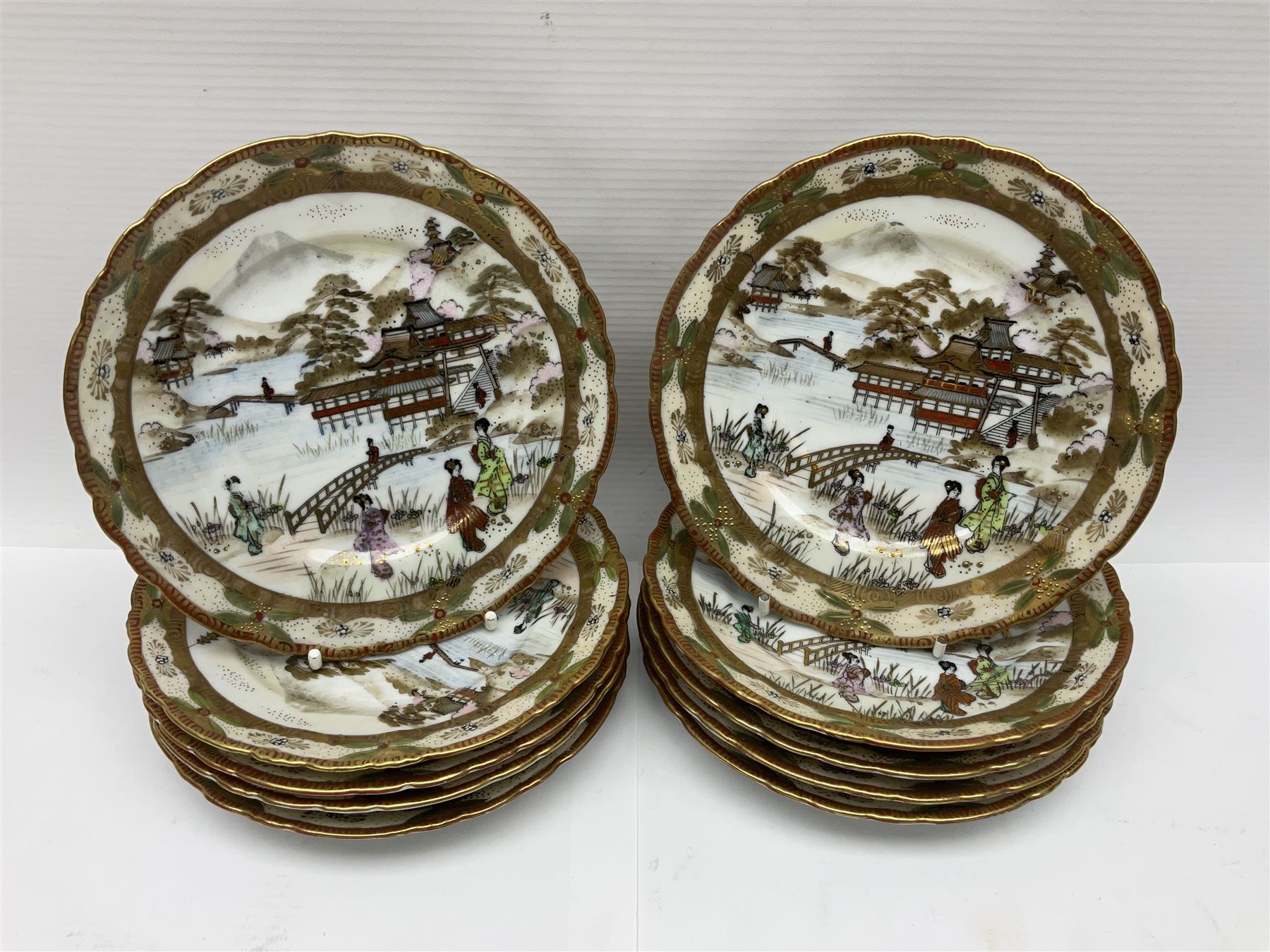 Noritake part tea service, printed and painted with figures in a landscape, comprising ten  tea cups and saucers, ten dessert plates, milk jug and sugar bowl