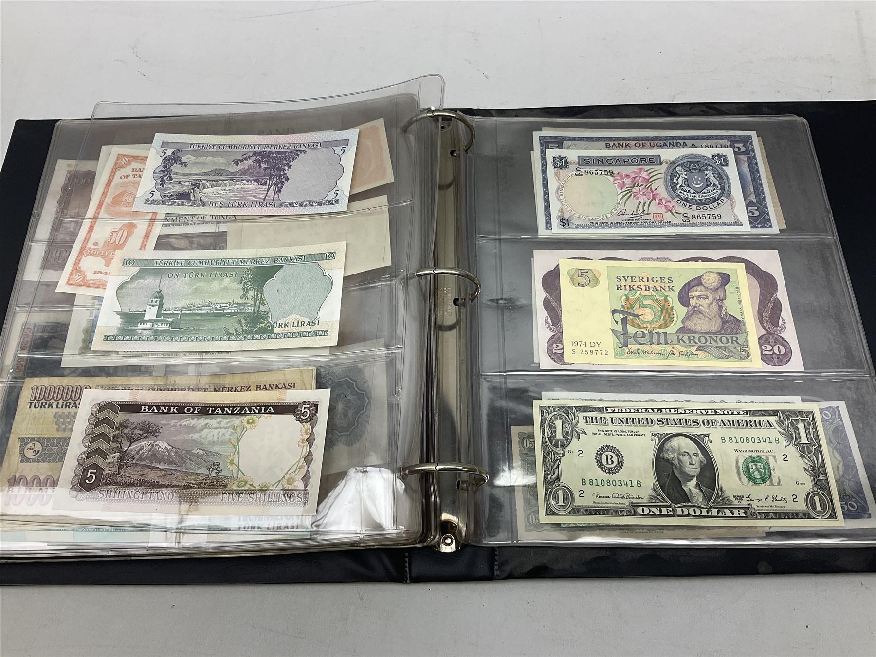 World banknotes, including Queen Elizabeth II The States of Jersey one pound 'DB202703', five pounds 'BB527762' and ten pounds 'AB651481', reserve bank of New Zealand two dollars '1L3 741894', King George V Straits Settlements one dollar 1st January 1935 'F/83 28924', various Bank of England notes etc, housed in two ring binder albums