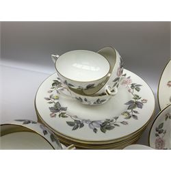 Royal Worcester June Garland pattern tea and dinner wares, comprising thirteen dinner plates, twelve dessert plates, twelve side plates, six twin handled soup bowls and six saucers, six small bowls, sauce boat and stand, thirteen teacups and fifteen saucers, open sucrier, and milk jug