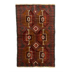 Baluchi red and blue ground rug, the field decorated with large six Gul motifs