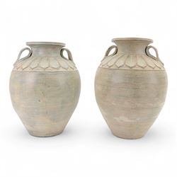 Two large Thai storage jars, with repeating leaf boarder to the neck