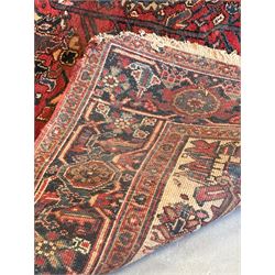 Persian Heriz red ground carpet, the field decorated with all-over geometric floral design within a guarded border, second quarter of the 20th century, 238cm x 339cm. - COLLECTION BY APPOINTMENT FROM: The White House, Thirsk Road, Easingwold, York, YO61 3NF - CALL 01723 507111 TO ARRANGE