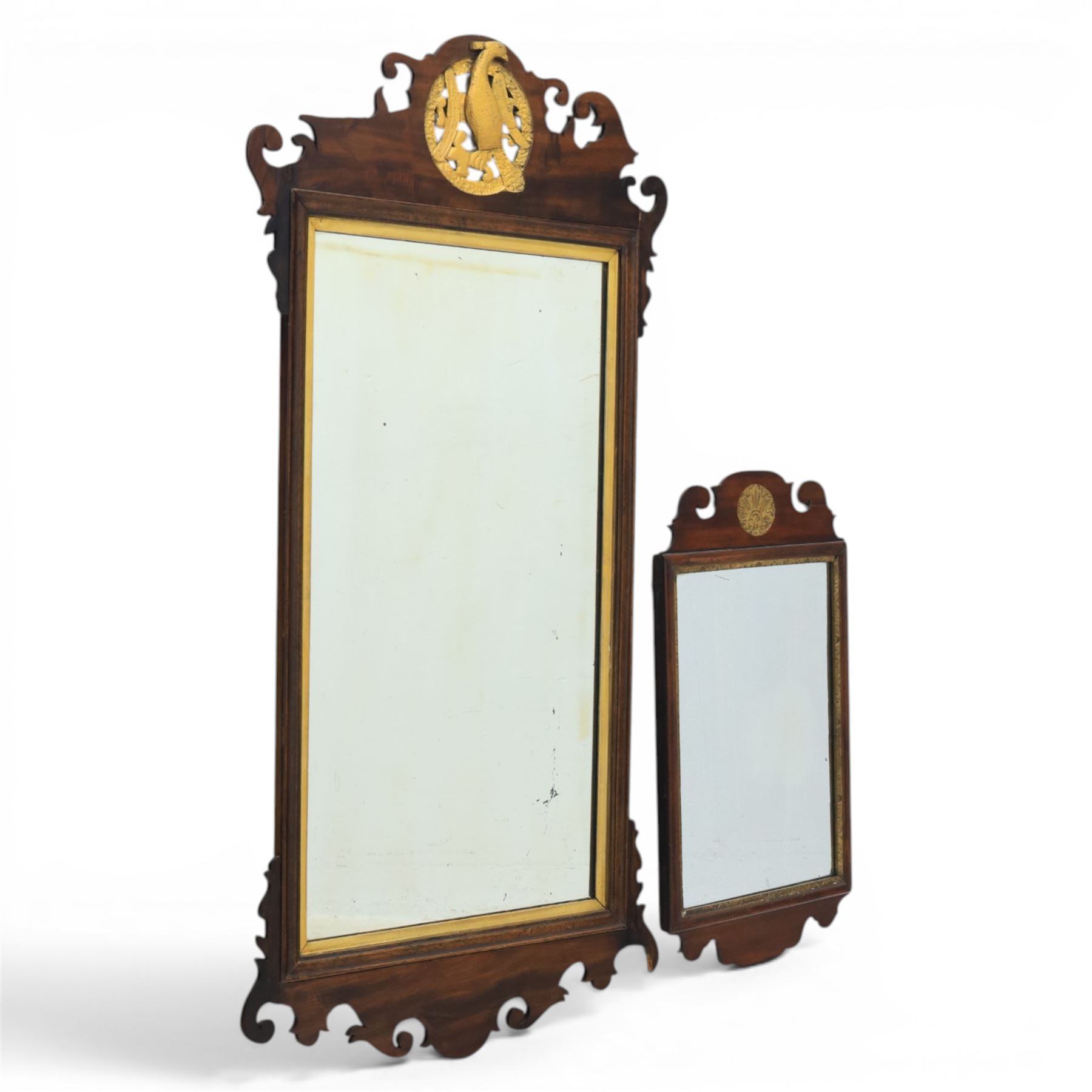 Late 19th century Chippendale style mahogany wall mirror, featuring gilded eagle pediment; together with a smaller similar mirror