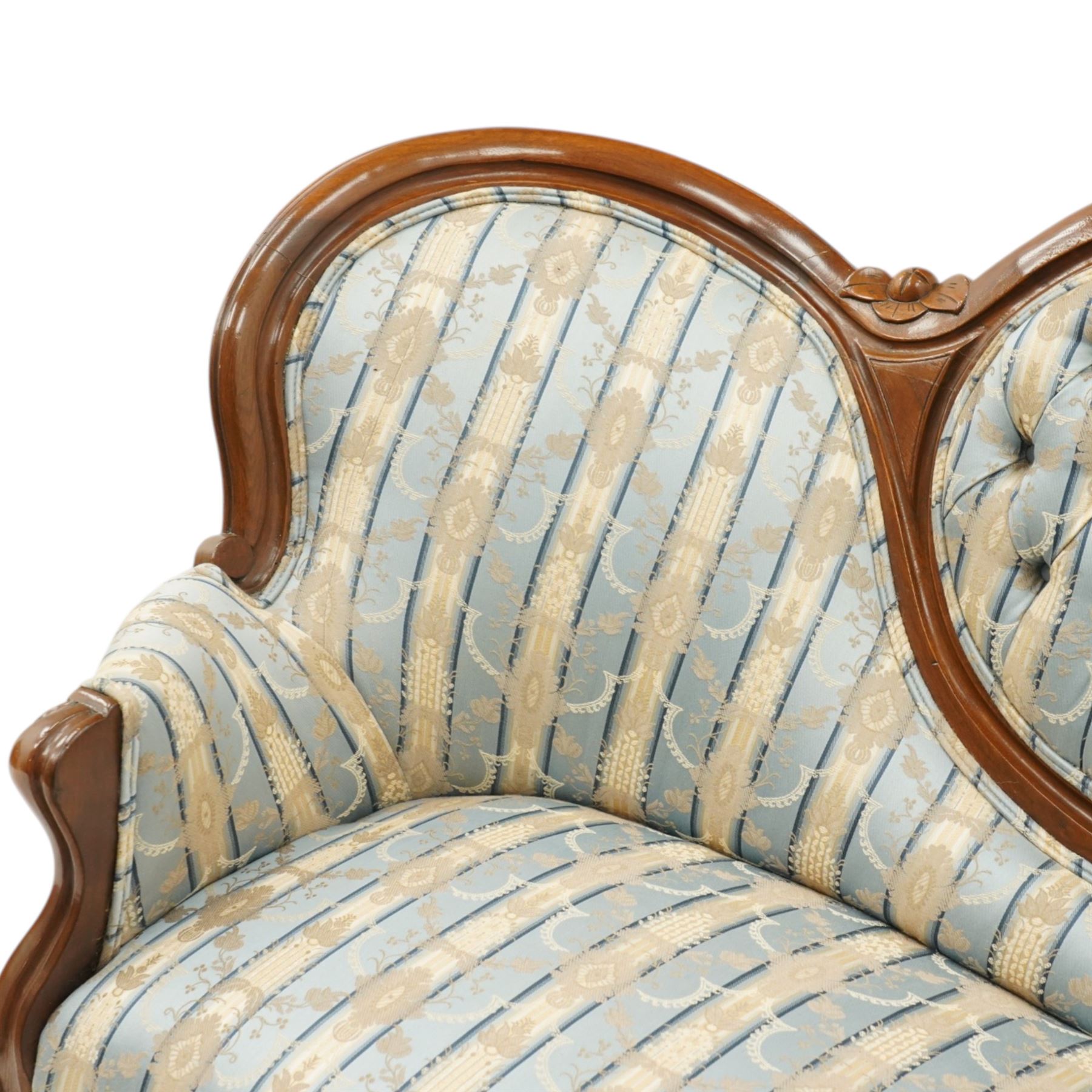 Victorian mahogany double cameo back sofa, the shaped back with central button upholstered oval panel and carved foliate crest above upholstered arms and seat, raised on cabriole legs terminating in castors