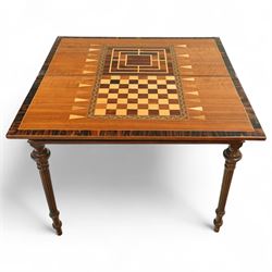 19th century mahogany fold-over card table, the crossbanded rectangular top opening to reveal an inlaid games centre with chessboard and backgammon designs, raised on turned and reeded legs with extending rear supports