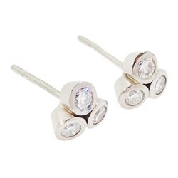 Pair of white gold bezel set, round brilliant cut diamond cluster stud earrings, total diamond weight approx 0.65 carat