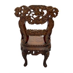 Chinese heavily carved hardwood armchair, serpentine seat