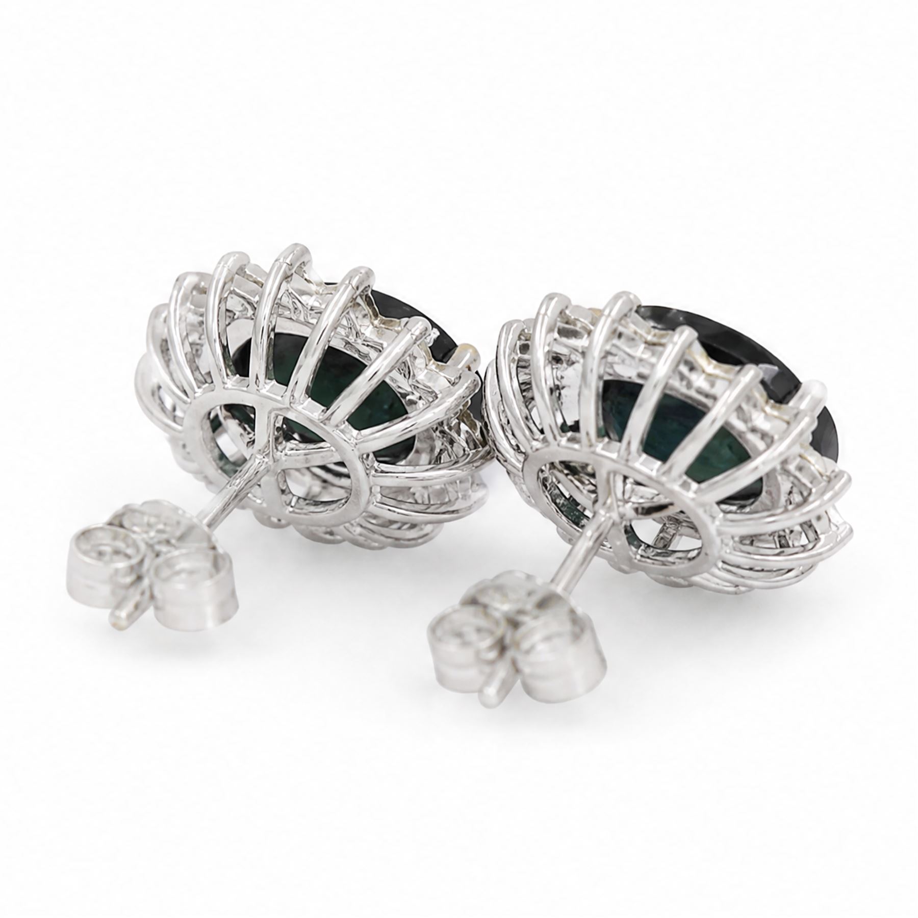 Pair of 18ct white gold sapphire and diamond cluster earrings, each stud set with a single oval cut sapphire, surrounded by sixteen round brilliant cut diamonds, total sapphire weight approx 6.65 carat, total diamond weight approx 1.00 carat