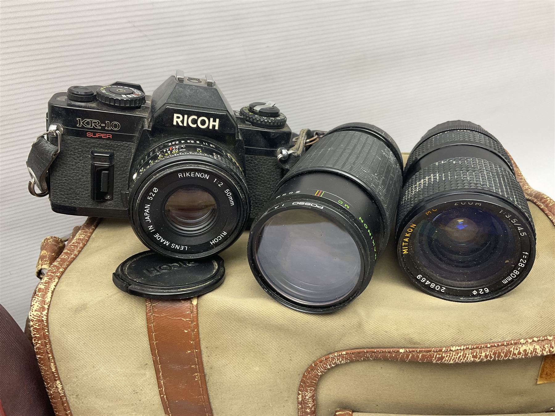 Cameras and accessories, to include Olympus OM101 Power Focus camera body, serial no 1076067, with 'Sigma AF Zoom 1:38, f=75 200mm' lens, serial no 2053714, Canon EOS 5000 camera body, serial no 1507812, with 'Canon Zoom EF 80-200mm, 1:4.5-5.6' lens, other cameras, by Miranda, Coronet and Ricoh and a collection of lenses, carry cases, etc 