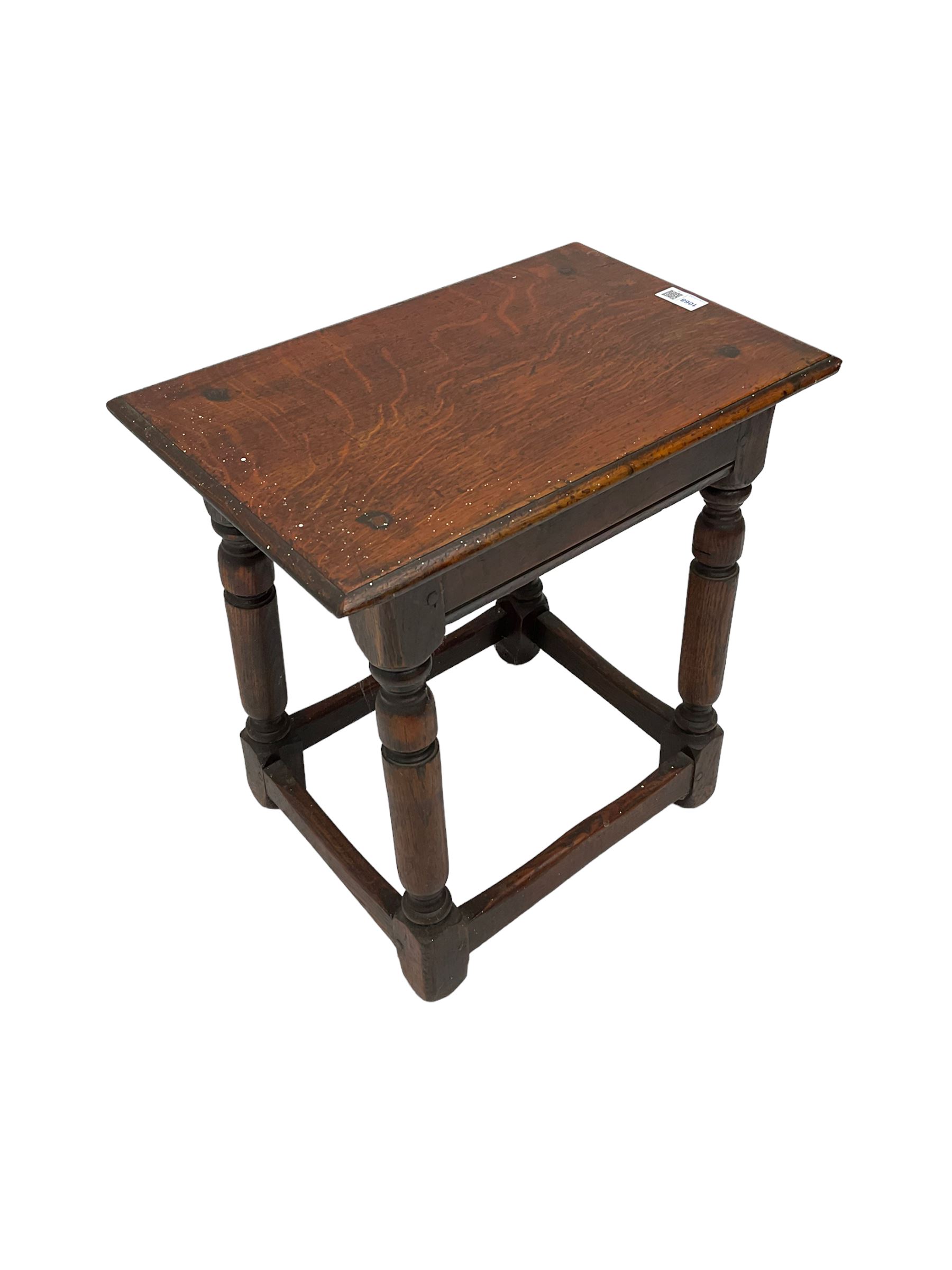 Oak coffin or joint stool, rectangular top with shaped edge over splayed turned supports with stretcher base 