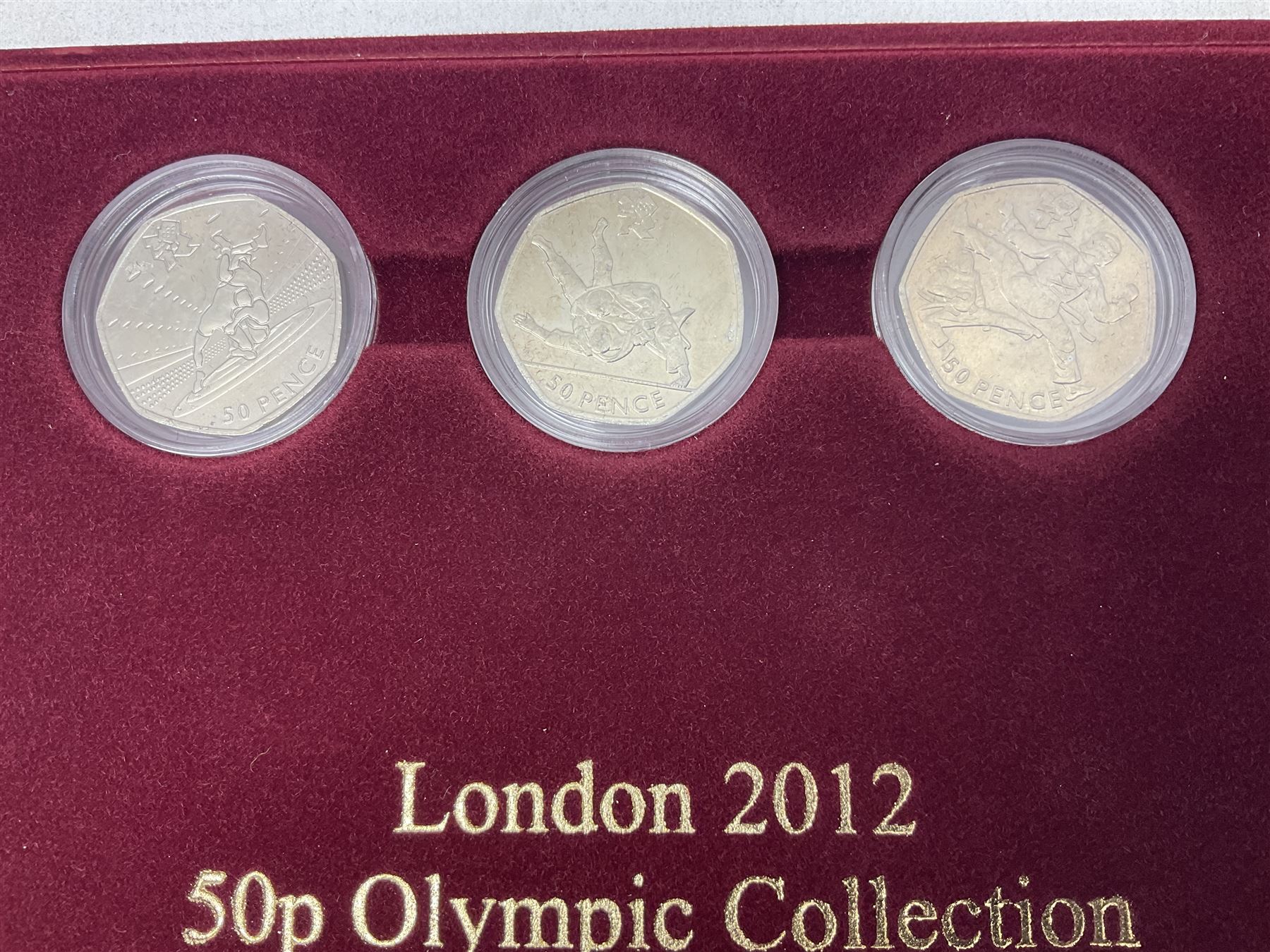 Queen Elizabeth II United Kingdom London 2012 Olympic commemorative fifty pence collection comprising twenty-nine coins, housed in unofficial display case