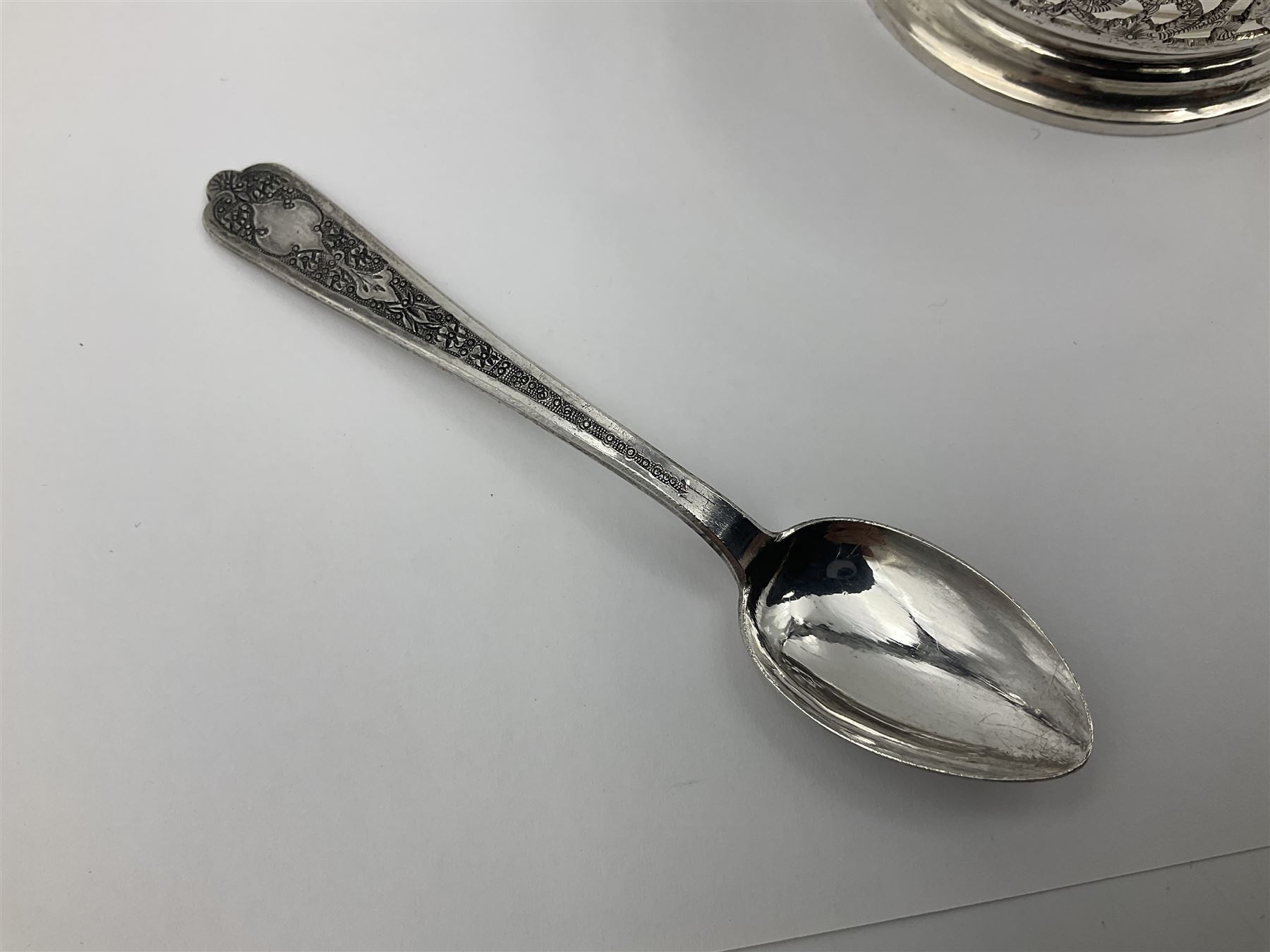 Early/mid 20th century Persian silver tea service, comprising circular serving tray, teapot, twin handled sucrier and cover, milk jug, five tea glasses with six silver holders, six tea spoons, and pair of sugar tongs, each profusely chased with foliate arabesque decoration, each bearing marks including 84 for 840 fineness, tray D40cm, teapot H16cm