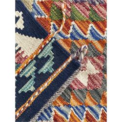 Chobi Kilim flatweave rug, dark navy ground with a vibrant multicoloured diamond lattice, framed by stylised border motifs, braided corner tassels