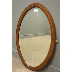  Victorian mahogany arch top wall mirror (W60cm, H132cm) and a mahogany inlaid oval bevel edge mirror, (W52cm, H73cm)  