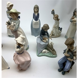 A group of thirteen Nao figurines, together with one Lladro figurine, each with printed mark beneath. 