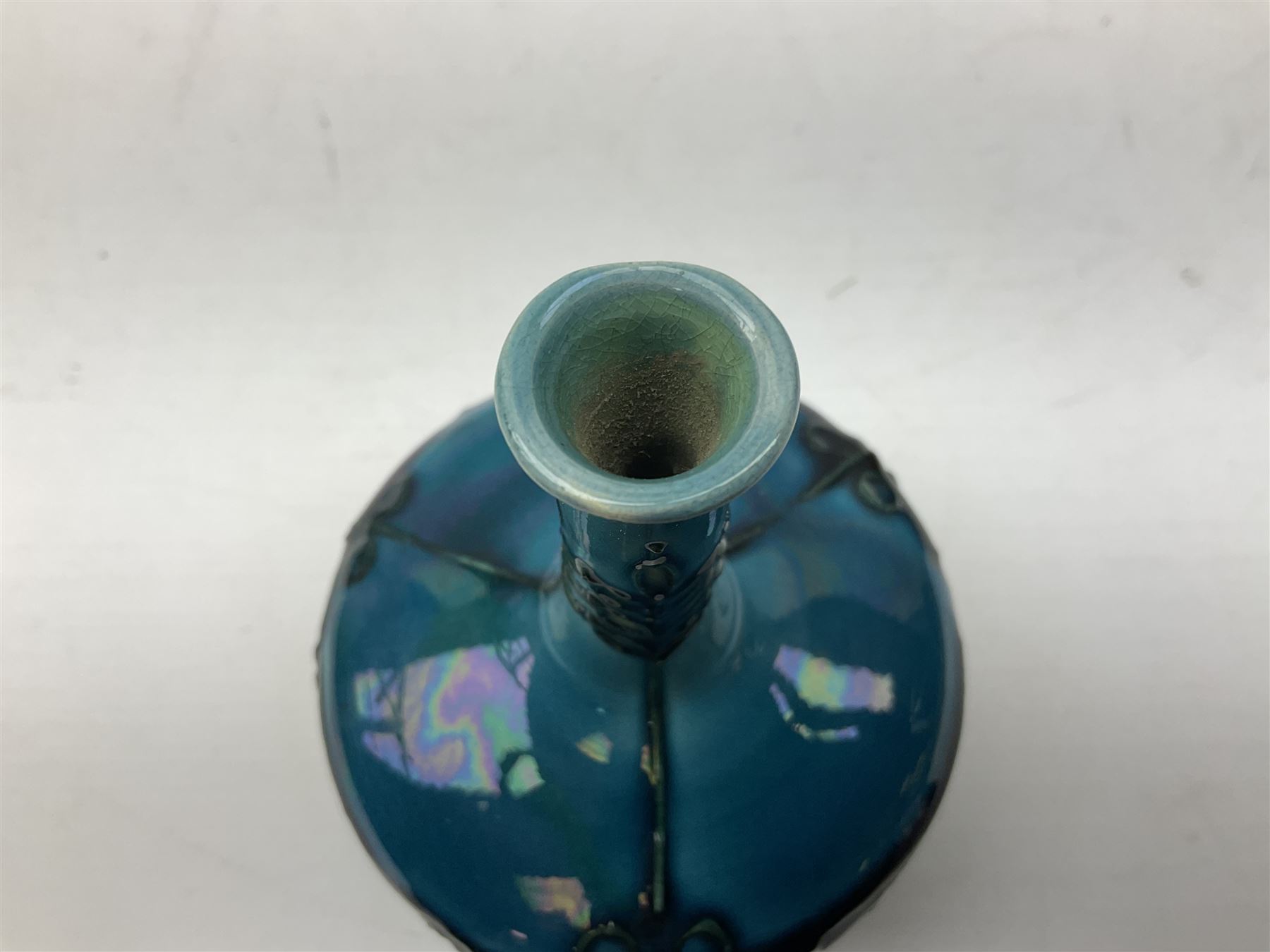 Minton Secessionist vase, with tube-lined stylised flower decoration, upon a blue ground, with printed mark to base 'Minton Ltd, No. 32', H13cm