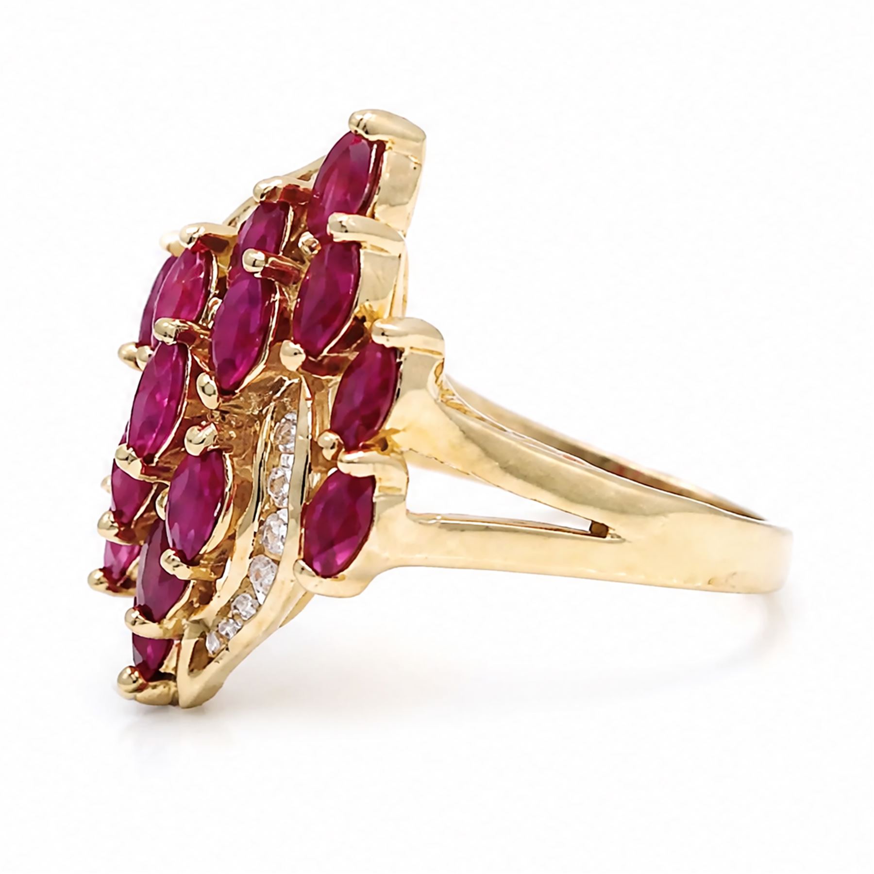 14ct gold ruby and diamond cluster ring, set with fifteen marquise cut rubies and fourteen channel set round brilliant cut diamonds, stamped 585