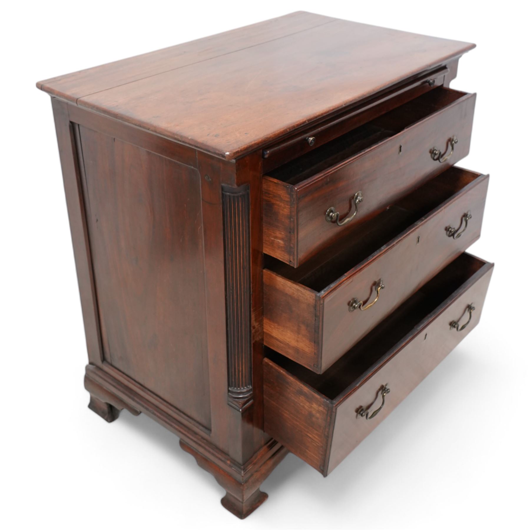 Georgian mahogany bachelor's chest, brushing slide over three long drawers, enclosed by canted corners with fluted quarter columns, on ogee bracket feet