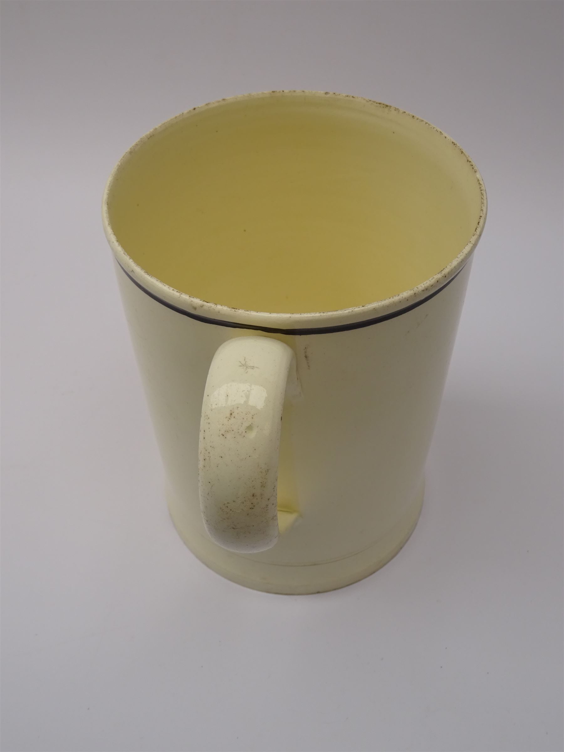 Early 19th century Sunderland Dawson & Co creamware pottery mug, the cylindrical body black transfer printed and polychrome detailed with a circular panel of a three-masted ship flanked by two figures of Peace and Plenty, above a panel containing verse 'May Peace with Plenty on our Nation smile [...]' H15cm D11cm