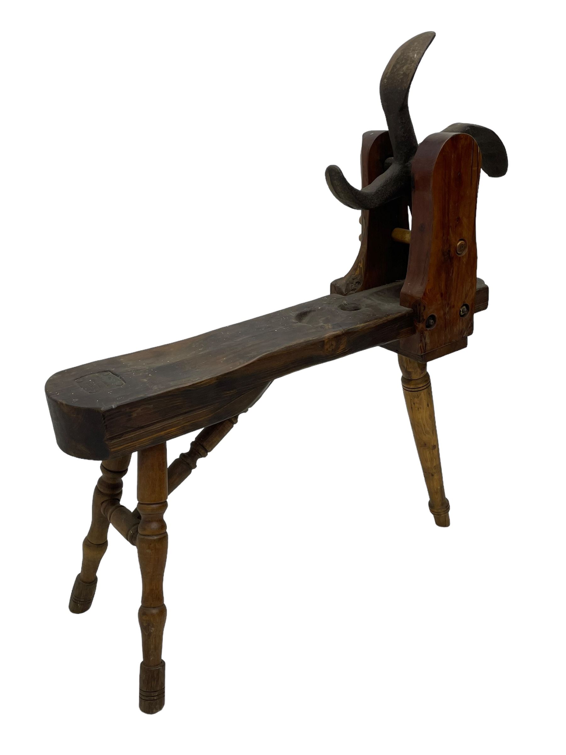 Early 19th century cobbler's work bench, in various woods, revolving cast iron last on yew wood supports, pine seat with inset maker's plaque inscribed 'No 7 Josh Blacker Harehills Leeds', on turned elm front supports and turned beech rear supports 