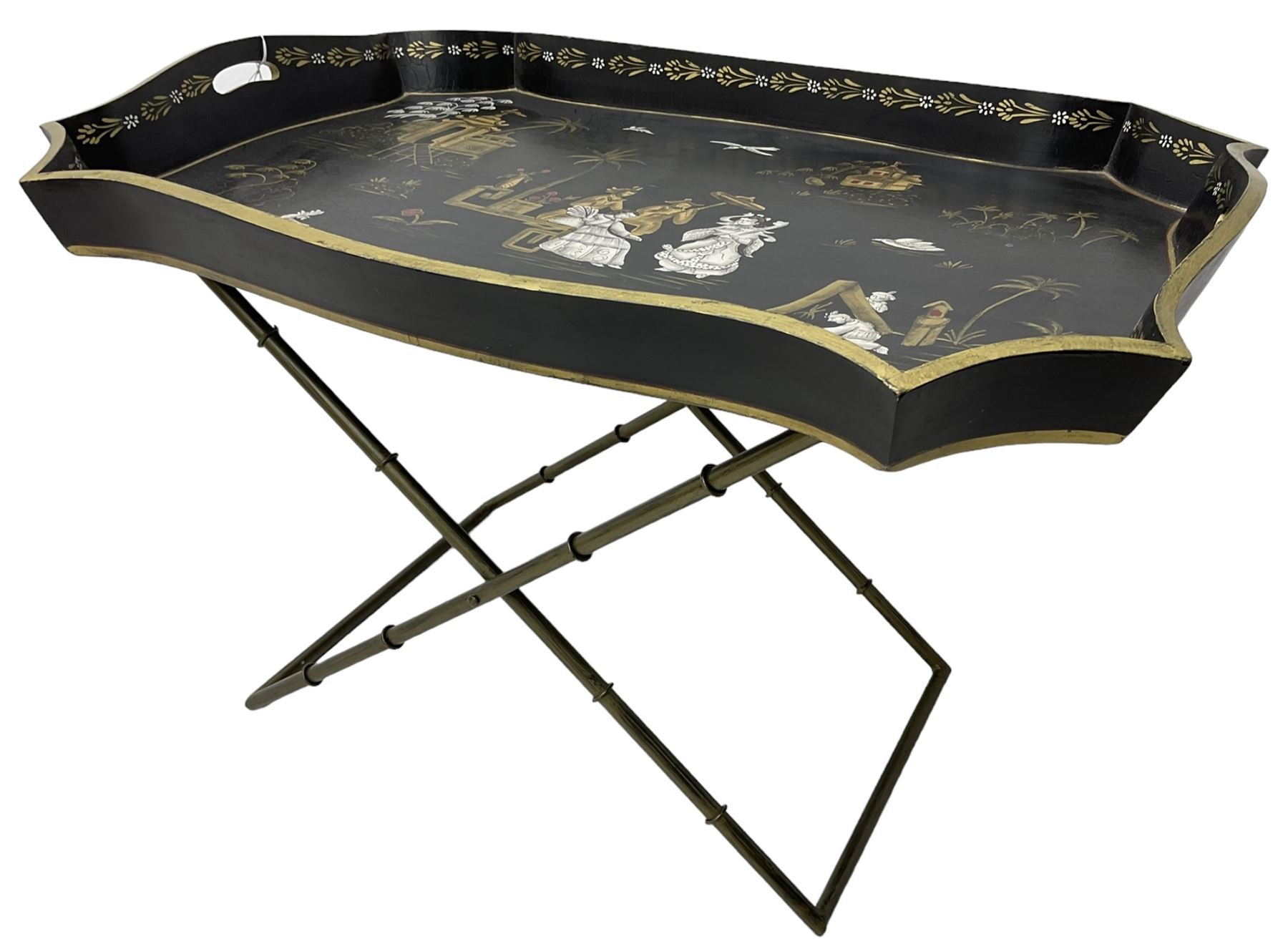 19th century design Chinoiserie style lacquered tray, painted with traditional scenes with figures and pagodas with gilt detail, on a folding simulated bamboo metal stand